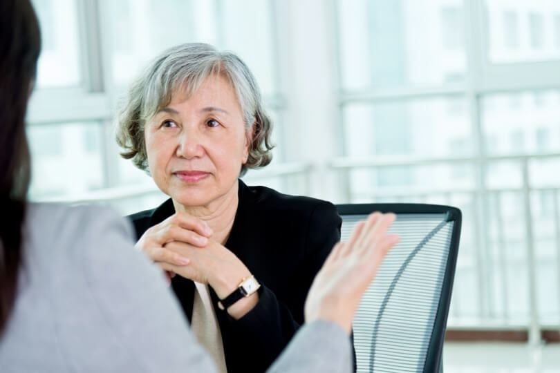 Photo of a woman facing another person